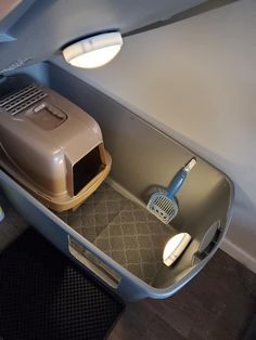 the inside of an airplane with a cat carrier and litter box