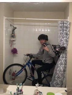 a person on a bike taking a selfie in the bathroom