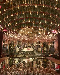 the inside of a building with lights hanging from it's ceiling and chandelier