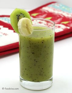 a green smoothie with a slice of kiwi on top