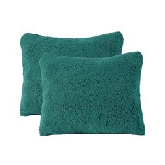 two teal pillows sitting next to each other