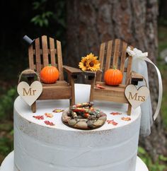 two wooden chairs sitting on top of a white cake