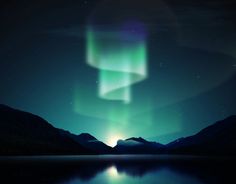 an image of the aurora bore in the night sky with water and mountains around it