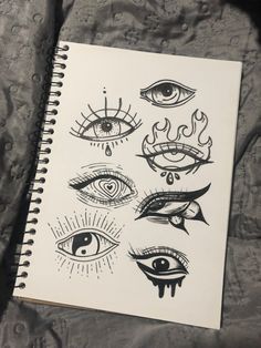 an open notebook with eye drawings on it