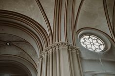 the inside of a cathedral with vaulted ceilings and round windows on either side of it