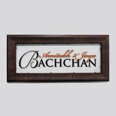 a wooden frame with the words baachhan written in orange and black on it