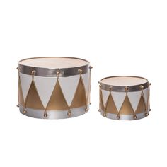 two white and gold drum stands with brass hardware on each side, one has a triangle design