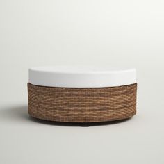 a white and brown basket sitting on top of a table