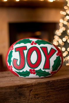 a decorated rock sitting on top of a wooden table