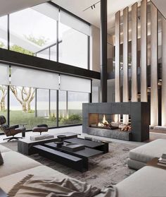 a modern living room with large windows and a fire place in the middle of it