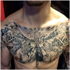 a man with tattoos on his chest is looking at the camera and has words written in it