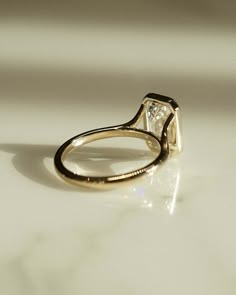 a diamond ring sitting on top of a table