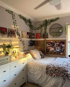 a bedroom with plants growing on the wall above the bed and below the bed is a dresser