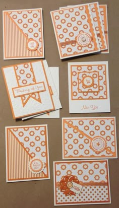 some cards with orange and white designs on them