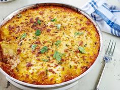 a casserole dish with cheese and herbs