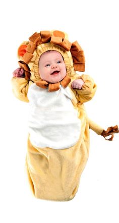 a baby in a lion costume laying on its back with it's arms up