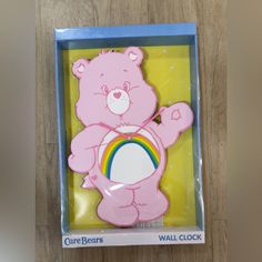 a pink bear with a rainbow on it's chest