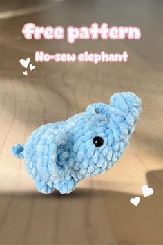 an elephant toy sitting on top of a wooden table next to a sign that says free pattern no sew elephant