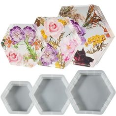 three hexagonal trays with floral designs on the sides and one is empty