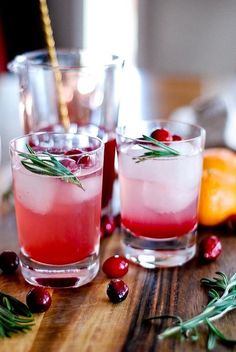 two glasses filled with cranberry and rosemary cocktails