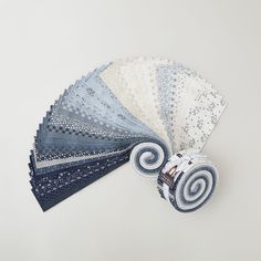 six pieces of blue and white fabric laid out on top of each other, with one folded in the middle