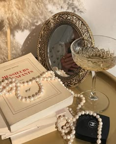 a table topped with pearls and a book