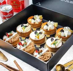 a box filled with lots of different types of desserts on top of a table