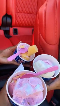 two people are holding ice cream in their hands