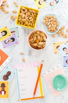 peanuts and other food items on a table with pictures around them, including a bowl of peanuts