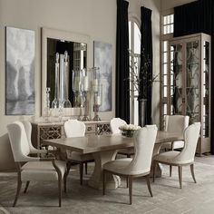 a dining room table with white chairs around it