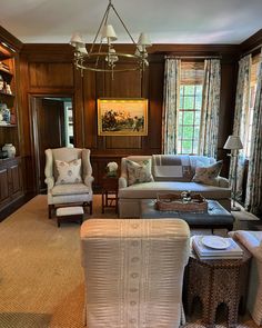 a living room filled with furniture and a chandelier