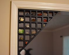 a mirror that has some kind of shelf on the side of it with rocks in it