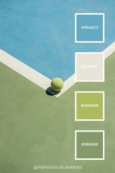 a tennis ball sitting on top of a court next to a blue and green wall