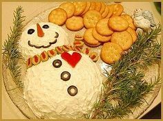 a frosted snowman cake with cookies and crackers