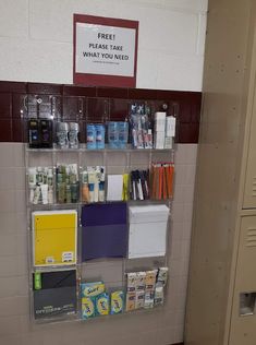 there is a shelf with many items on it in the bathroom stall, and one has a sign that says free toilet care what - you need