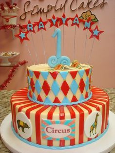 a circus themed birthday cake with the number one on top