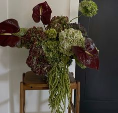 a bouquet of flowers sitting on top of a wooden chair