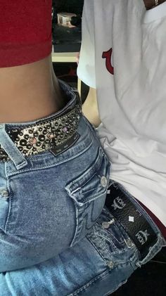 the back of a person's jeans with an embellishment on their waist