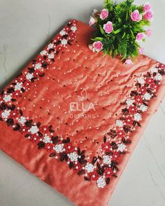 an orange table cloth with flowers on it