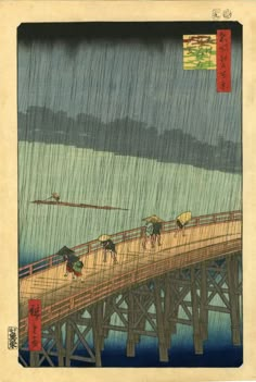 an image of people walking across a bridge in the rain