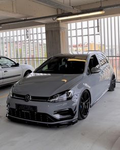 two cars parked in a parking garage next to each other