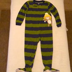 Carter’s Size 5t Footed Pajamas. Olive Green And Navy Blue 1.5" Horizontal Stripes. Zips From Neck To Foot Down The Left Leg. Embroidered Beige, Brown, And White Waving Monkey Character Wearing A Yellow And White Ski Cap Is On Right Chest. Very Good Used Condition. Possibly Never Worn, Maybe On Holiday Trips To Grandma And Grandpa's. No Pilling At Sleeve Or Neck Cuffs. No Stains, Rips, Tears. Footy Bottoms Feature Grey Shiny Accents And Carter's Logos. Flame Resistant. 100% Polyester Exclusive O Olive Green And Navy Blue, Footy Pajamas, Monkey Character, Footed Pajamas, Ski Cap, Sleepover Activities, Toddler Boy Fashion, Sleepover Party, Pajama Party