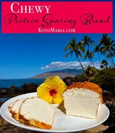 a white plate topped with slices of cake next to a flower on top of a rock