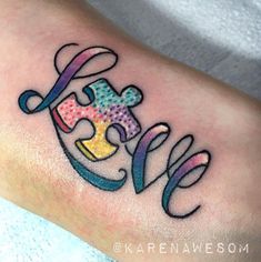 a person with a colorful tattoo on their leg holding a piece of the same puzzle