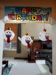 two paper turkeys hanging from the ceiling with happy birthday written on it's side