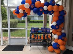 an orange, white and blue balloon arch