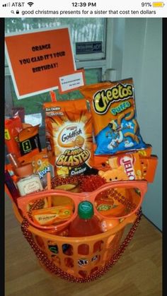 an orange basket filled with snacks and candy