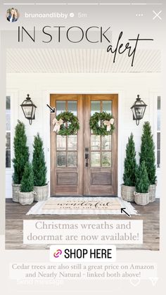 the front door is decorated with christmas wreaths and potted trees for holiday decor