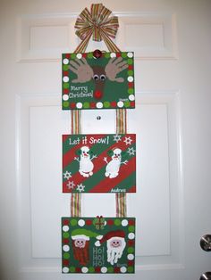 the door is decorated with christmas decorations and handprinted cards for santa's helpers