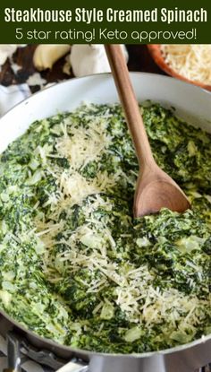 spinach and cheese in a skillet with a wooden spoon